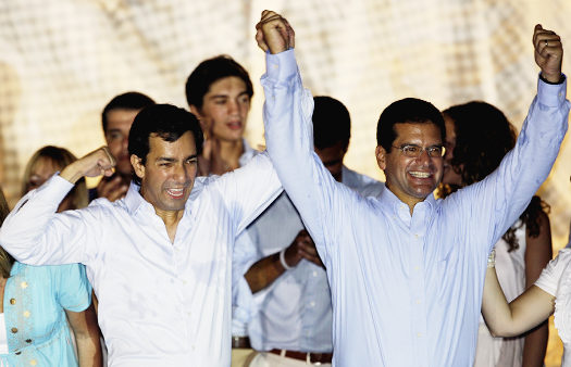 Puerto Rico's governor-elect Luis Fortuño, left, and Resident Commissioner-elect Pedro Pierluisi, elected nonvoting delegate to U.S. Congress, celebrate during the victory rally in San Juan, Puerto Rico, Tuesday, Nov. 4, 2008. (AP Photo/Andres Leighton)